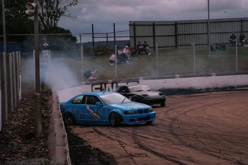 Hero image of a car going around a race track
